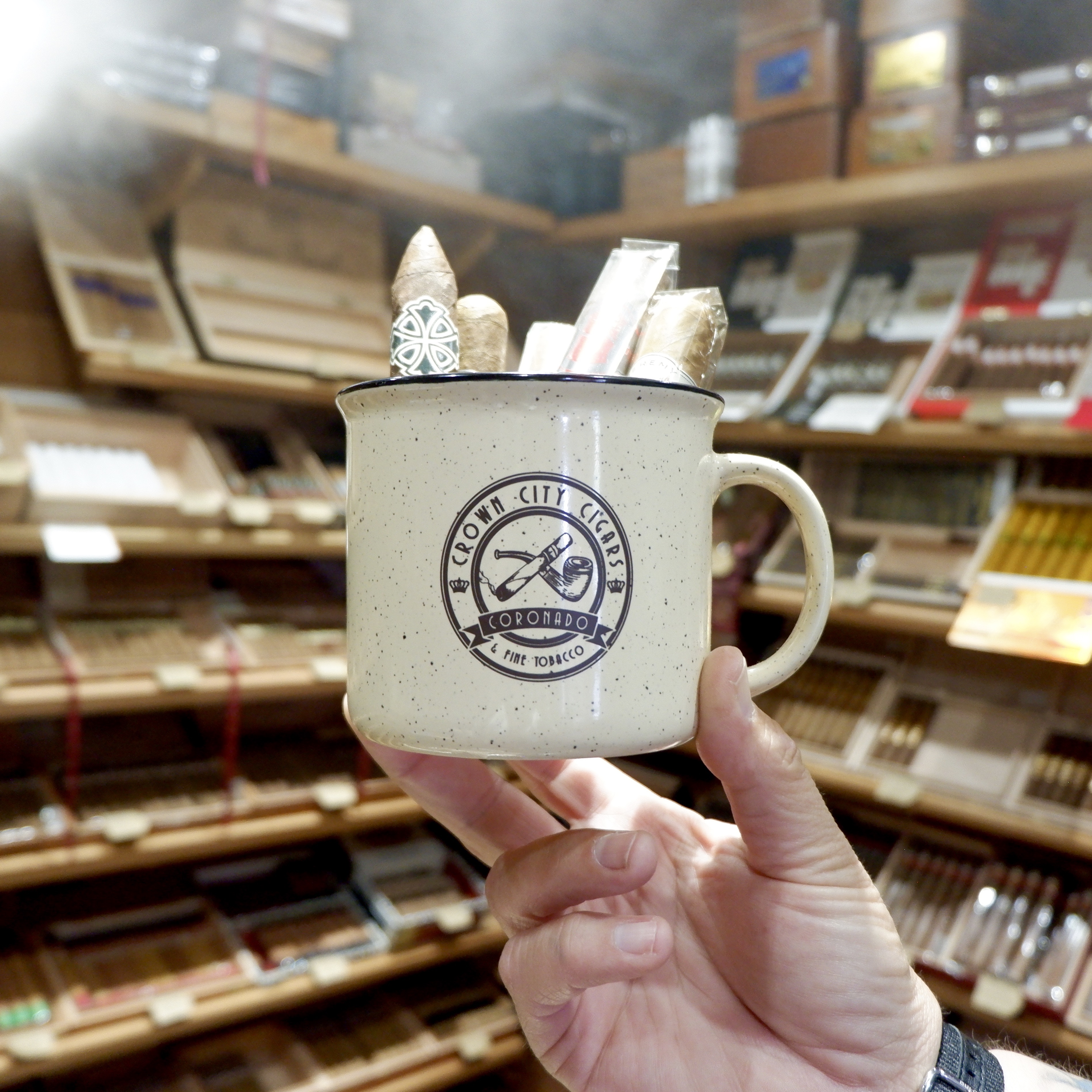 cup of cigars branded with Crown City Cigars logo in the humidor